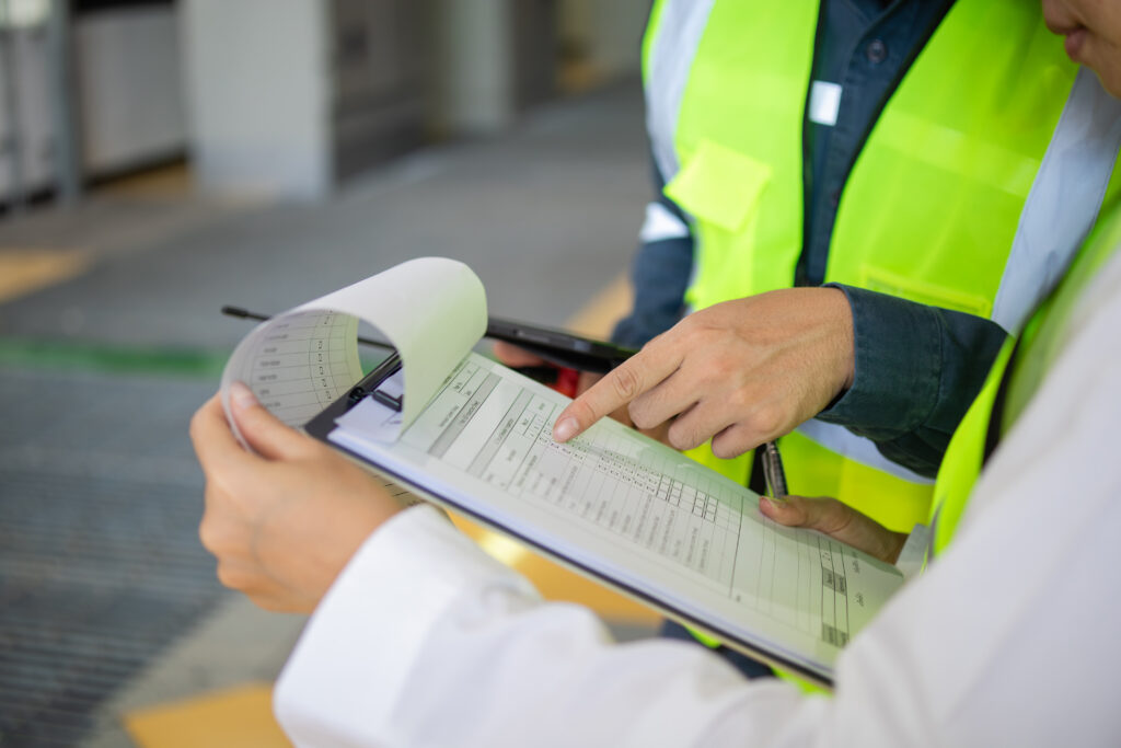 Construction Surveillance Technicians working on documentation and compliance.